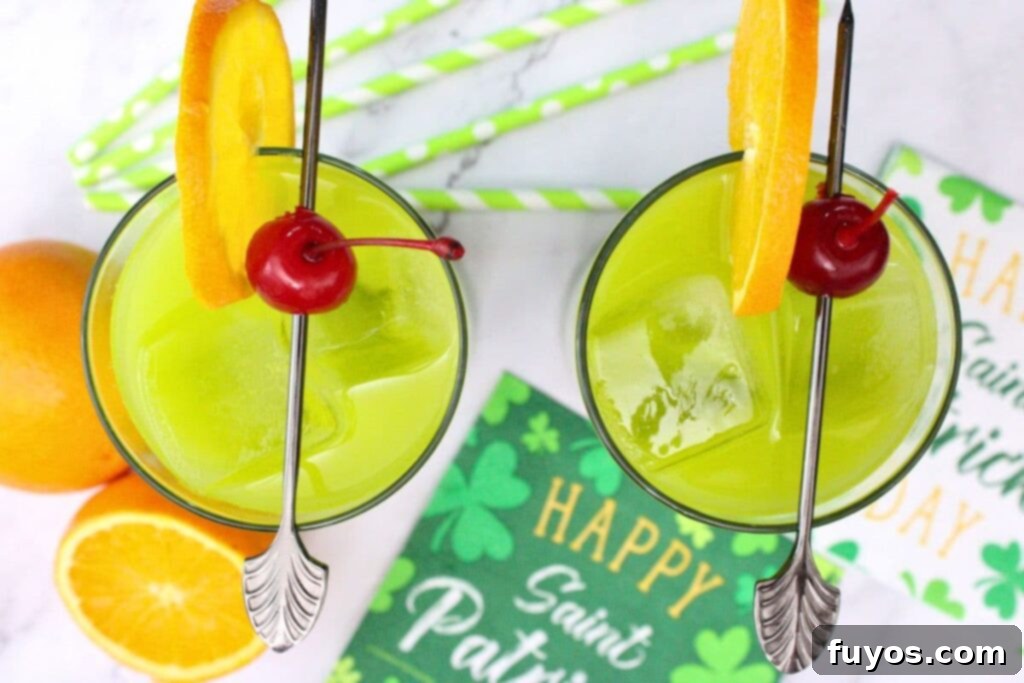 St. Paddy's Drunken Leprechaun Irish Screwdriver 8 Overhead view of two finished Drunken Leprechaun drinks garnished with orange and cherries