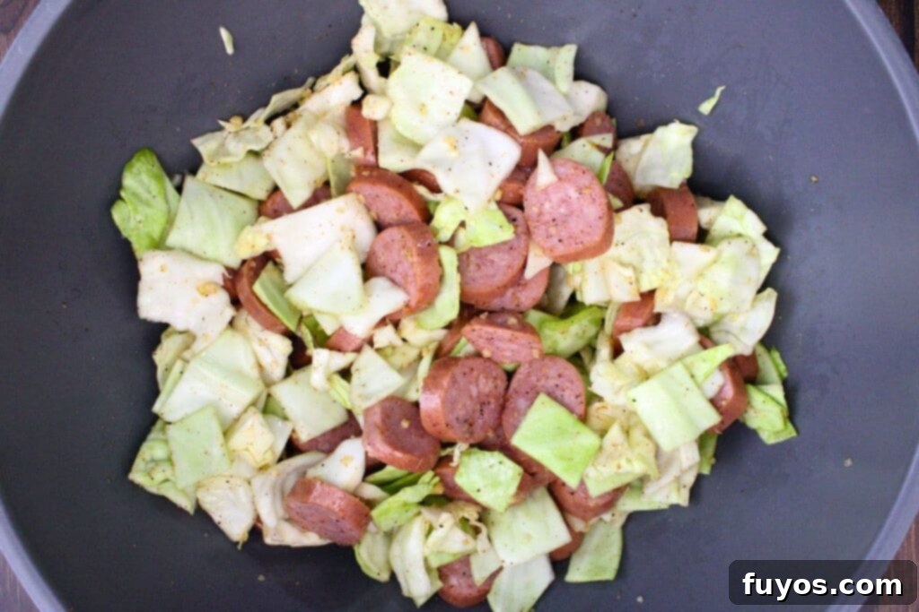 toss sausage and cabbage with olive oil, garlic, and cajun seasoning