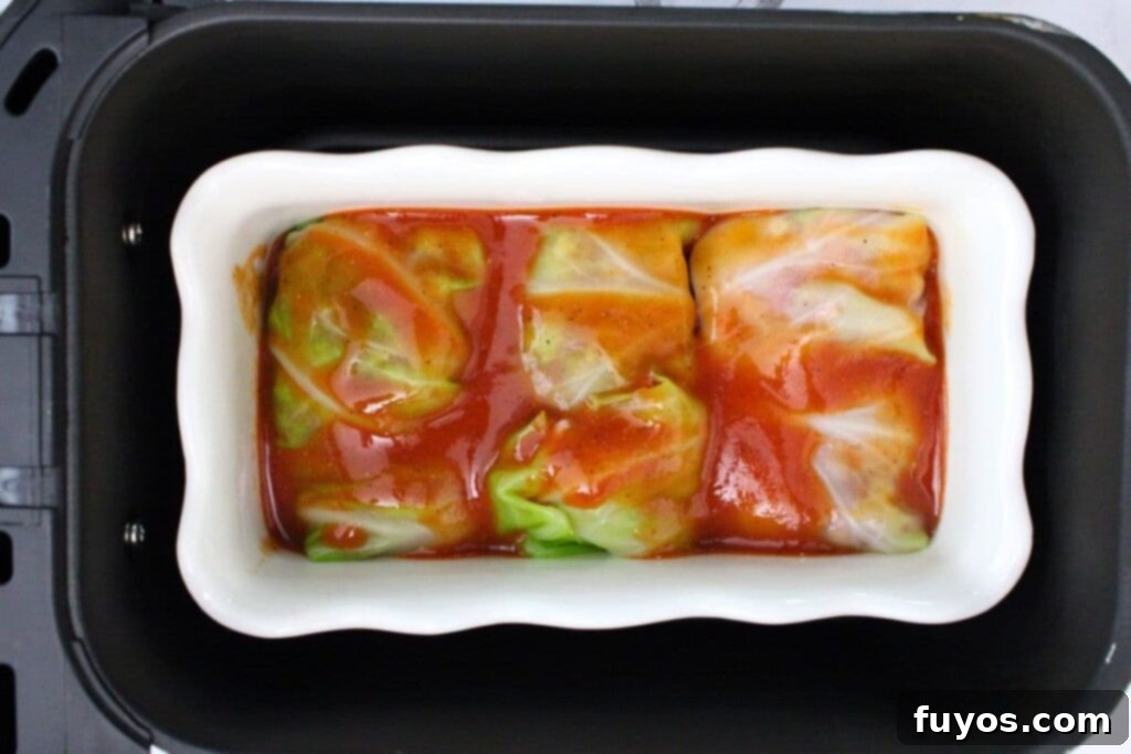 Savory Air Fryer Cabbage Rolls with Sausage and Rice 11 add cabbage rolls in pan to air fryer basket