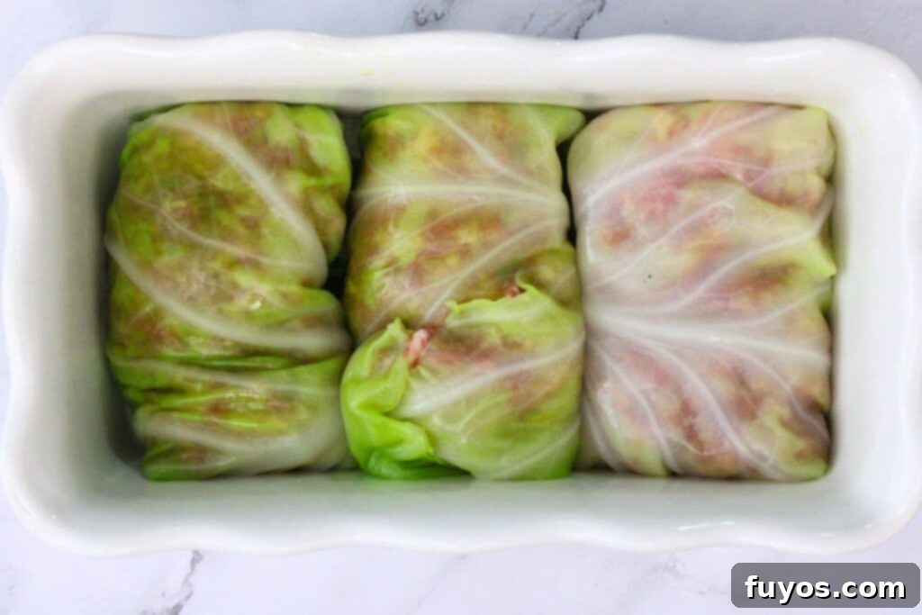 Savory Air Fryer Cabbage Rolls with Sausage and Rice 9 add cabbage rolls seam side down to oven safe pan