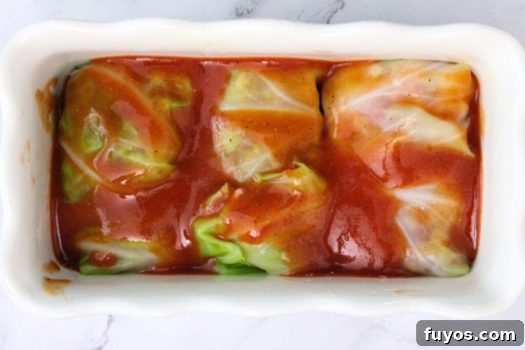 Savory Air Fryer Cabbage Rolls with Sausage and Rice 10 pour sauce over top of the cabbage rolls