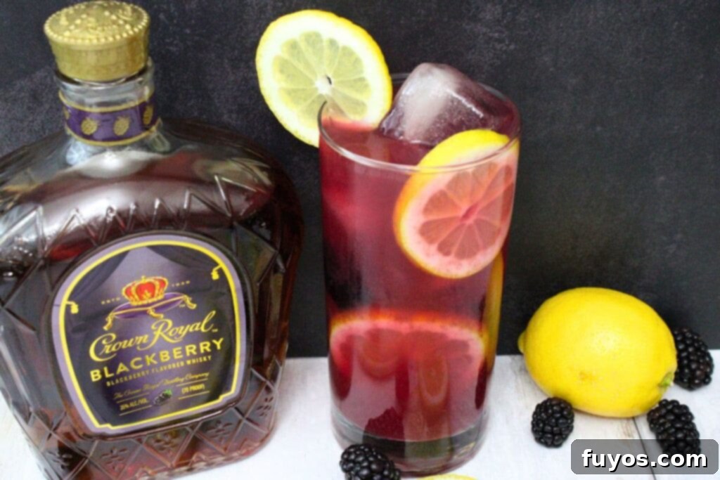 Crown Jewel Blackberry Lemonade: Two-Ingredient Elixir 9 tall glass of crown blackberry lemonade next to the special edition crown royal bottle
