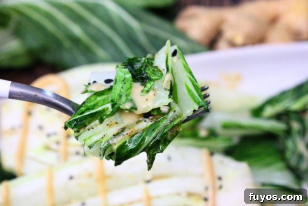 holding up a forkful of air fryer bok choy