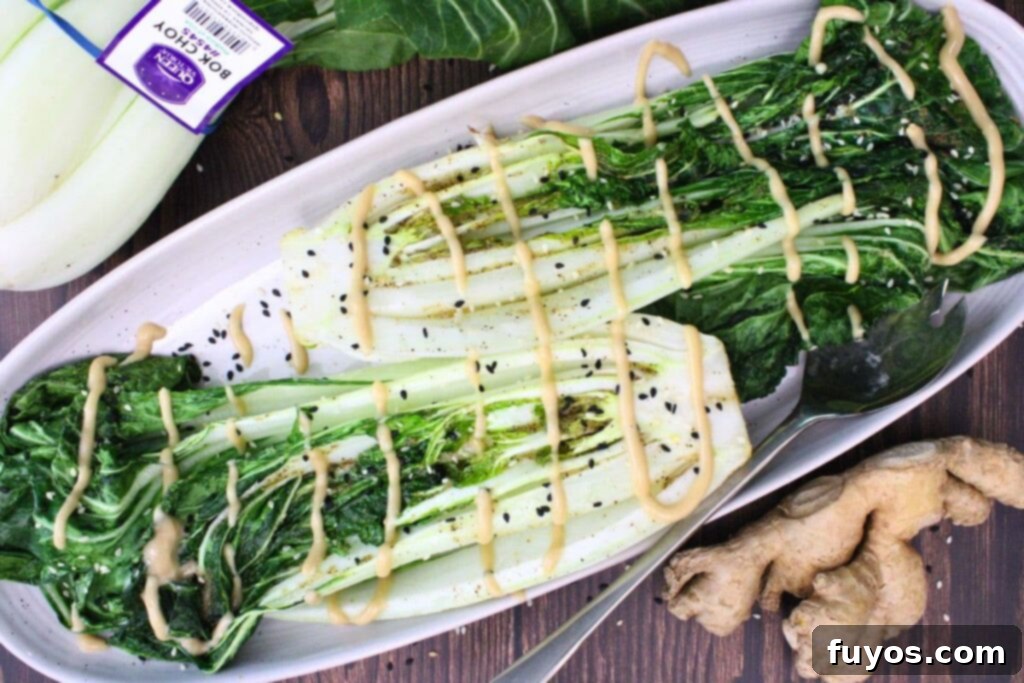 overhead view of two heads of air fryer bok choy with a sesame ginger drizzle