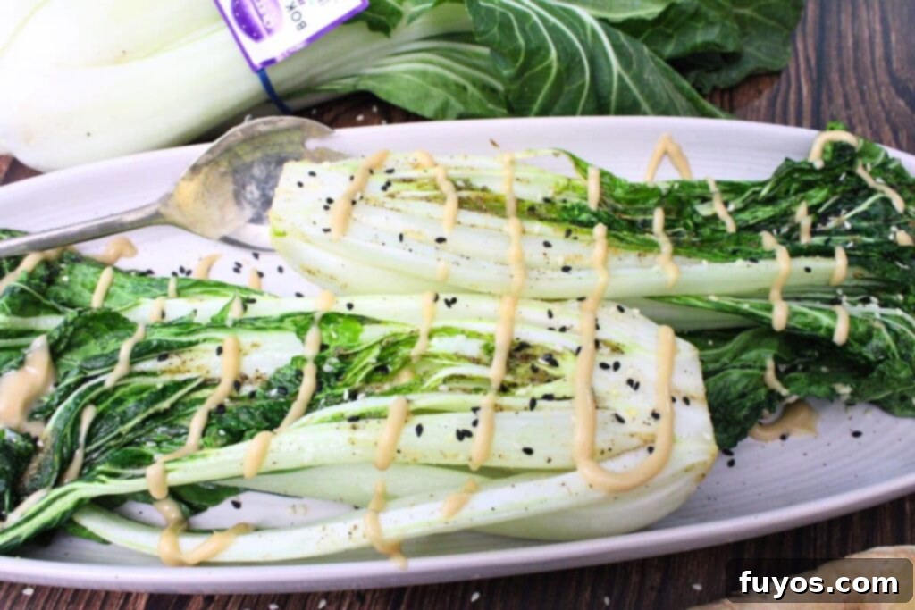 two heads of air fryer bok choy laying across a serving platter