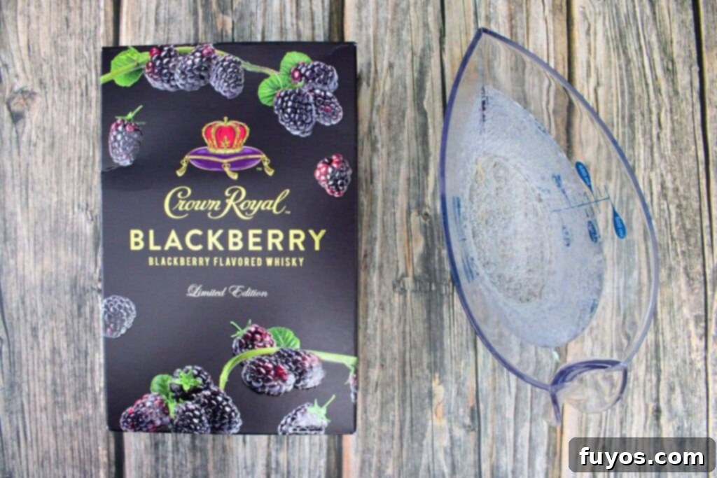 Ingredients needed to make Crown Royal Blackberry and Sprite cocktail, including whiskey bottle, Sprite can, and ice.
