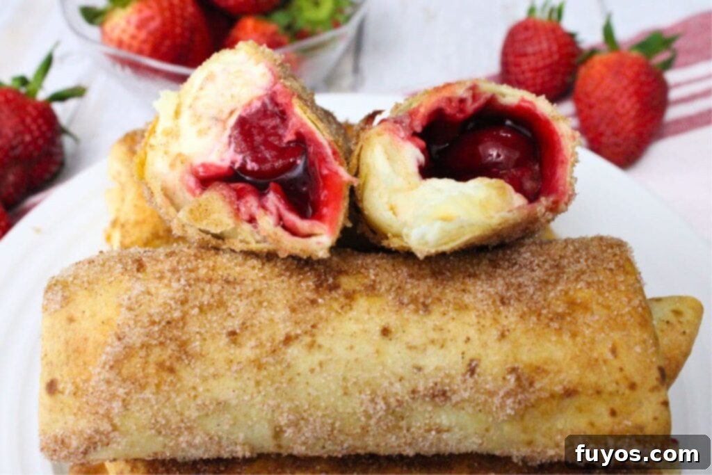 two halves of a cheesecake chimichanga laying on top of an uncut one
