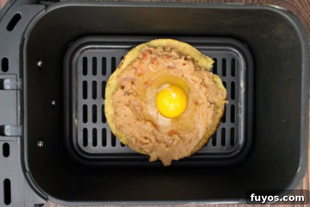 Air Fried Huevos Rancheros Zesty Mexican Breakfast 8 place tostada with egg in air fryer basket