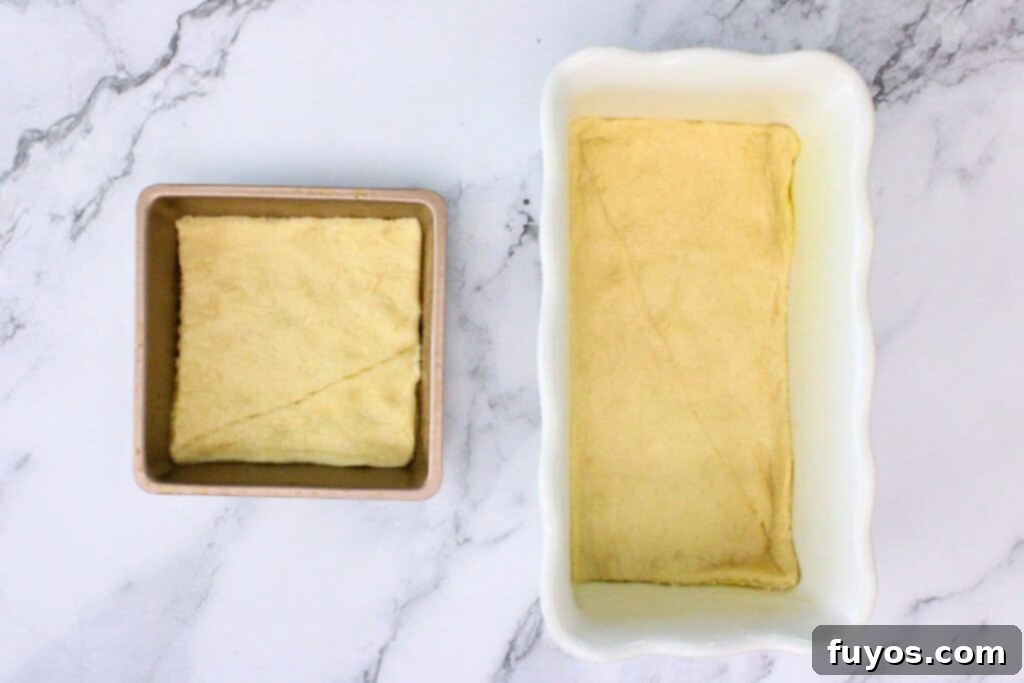 press one sheet of crescent dough in the bottom of the baking dish