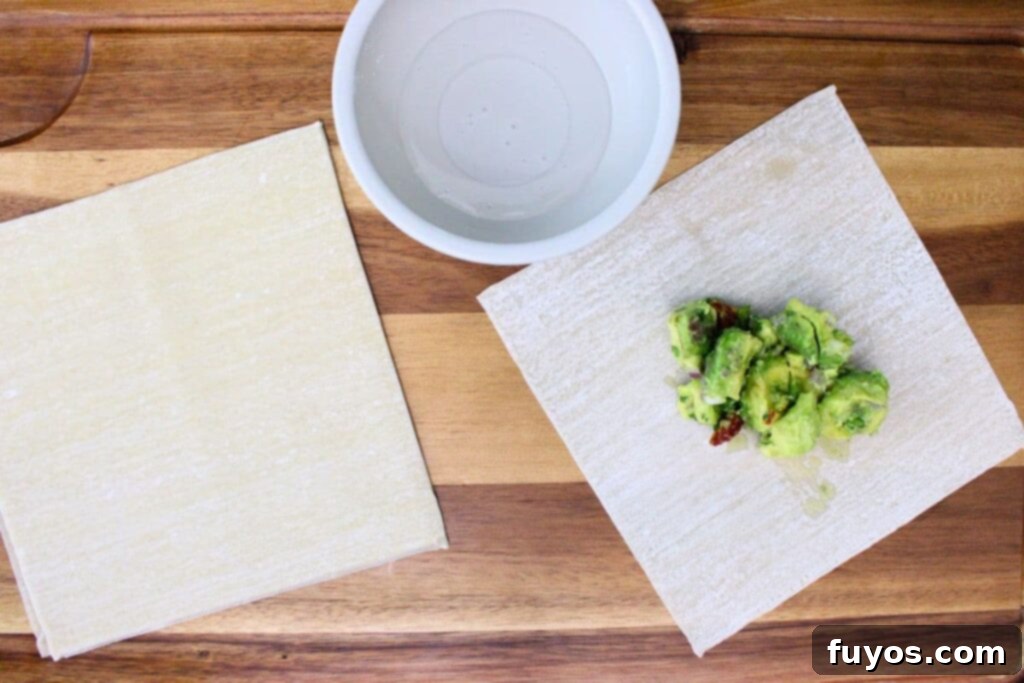 Air Fryer Copycat Cheesecake Factory Avocado Egg Rolls 7 place avocado filling in the center of egg roll wrapper for easy rolling