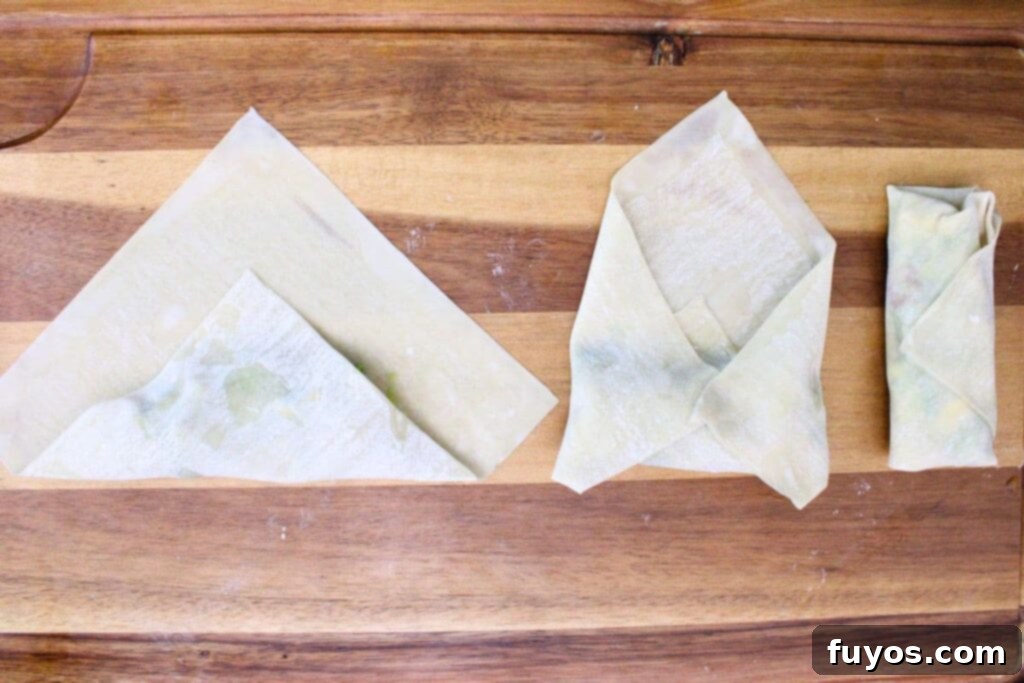 Air Fryer Copycat Cheesecake Factory Avocado Egg Rolls 9 carefully fold the egg roll wrapper over the avocado filling, then roll tightly
