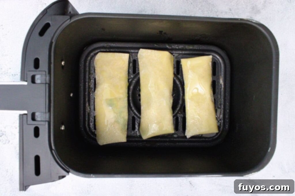 Air Fryer Copycat Cheesecake Factory Avocado Egg Rolls 10 place avocado egg rolls in air fryer basket in a single layer for even cooking