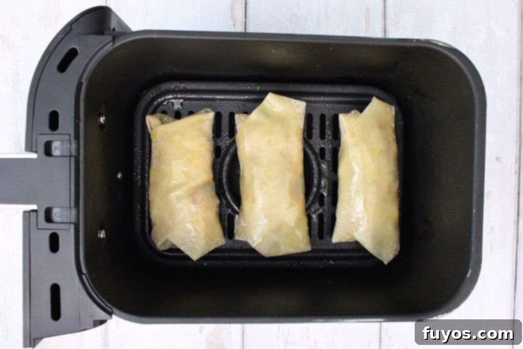 place taco egg rolls in air fryer basket
