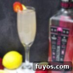 Pink Whitney Infused Strawberry Pink Lemonade Mimosa 10 A vibrant pink lemonade mimosa, garnished with fresh fruit, inviting to be shared.