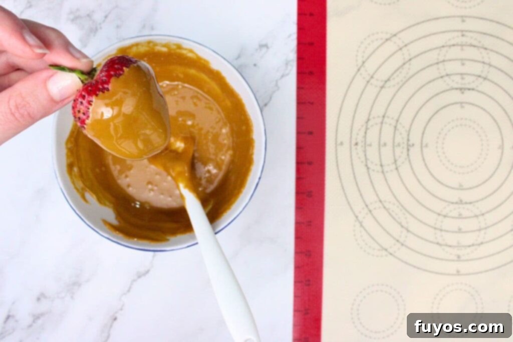 Two Ingredient Caramel Strawberry Delight 7 dip the strawberries by the stem into the melted caramel