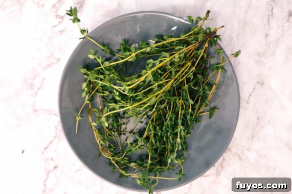 Effortless Microwave Thyme Drying 3 sprigs of fresh thyme cleaned on a plate