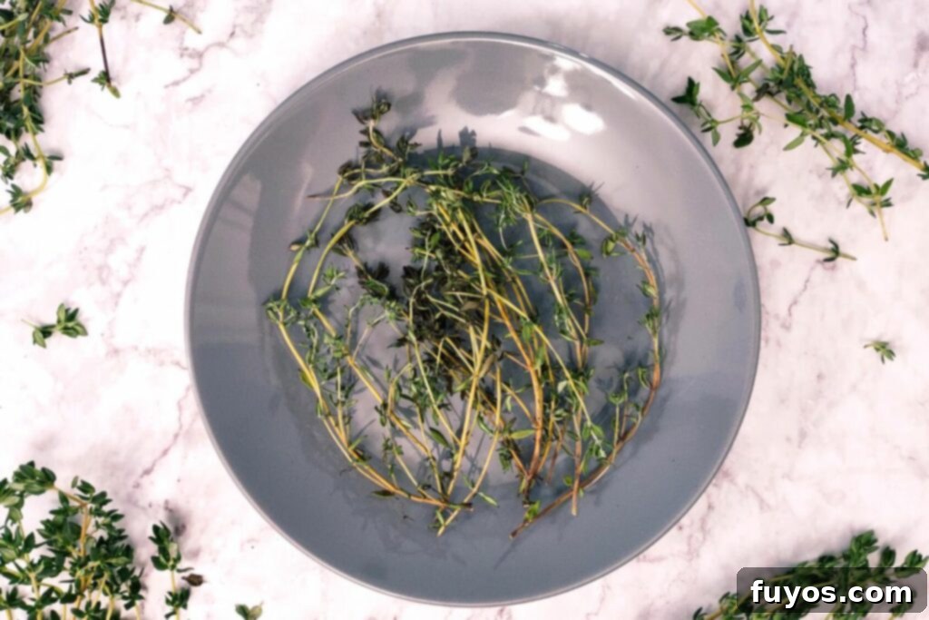 Effortless Microwave Thyme Drying 6 microwave dried thyme sprigs in a circle on a plate