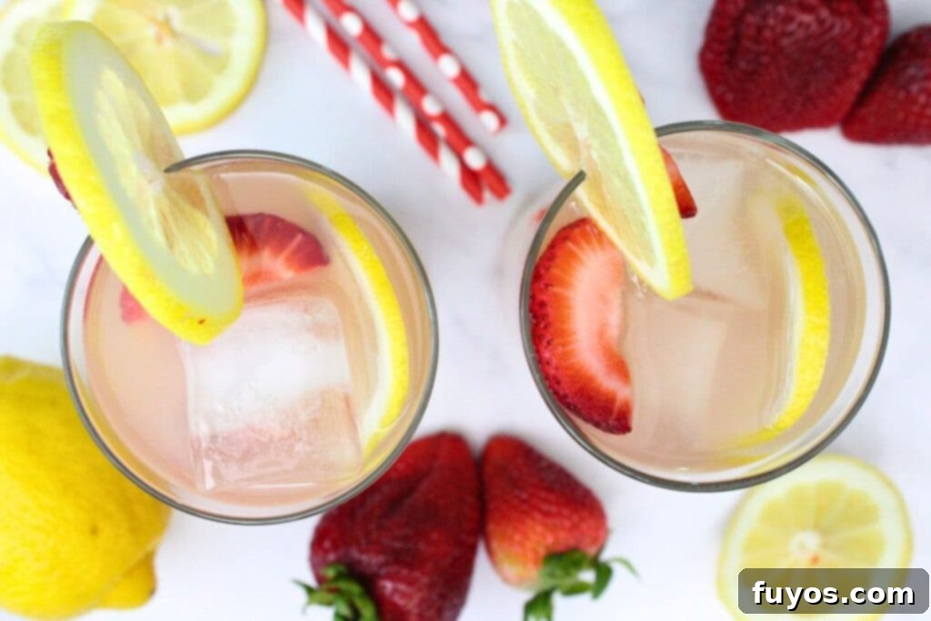 Easy Summer Strawberry Vodka Lemonade Recipe 8 overhead view of two strawberry vodka lemonade drinks surrounded by fresh fruit