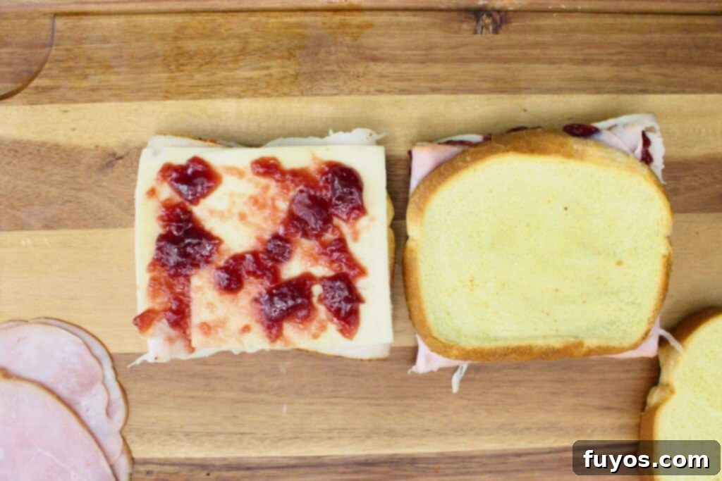 Air Fryer Monte Cristo A Taste of Disneyland 5 add turkey, cheese, raspberry jam, and ham to slices of bread