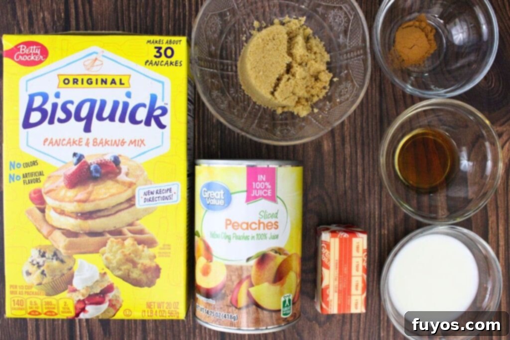 All the necessary ingredients laid out to make peach cobbler in the microwave, including canned peaches, Bisquick, butter, sugar, cinnamon, and vanilla.