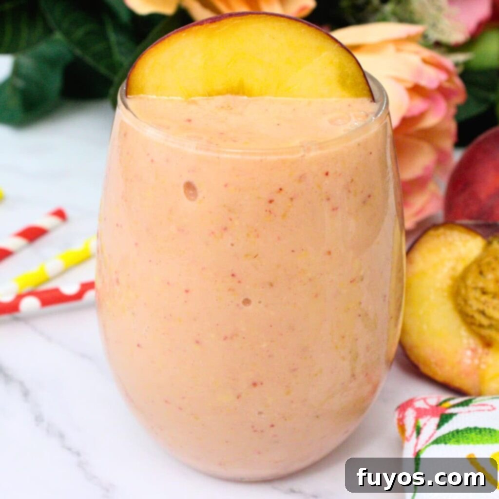 Peach Strawberry Mango Summer Bliss Smoothie 2 A vibrant peach strawberry mango smoothie, ready to be enjoyed. This refreshing drink is perfect for summer breakfasts or an afternoon pick-me-up.