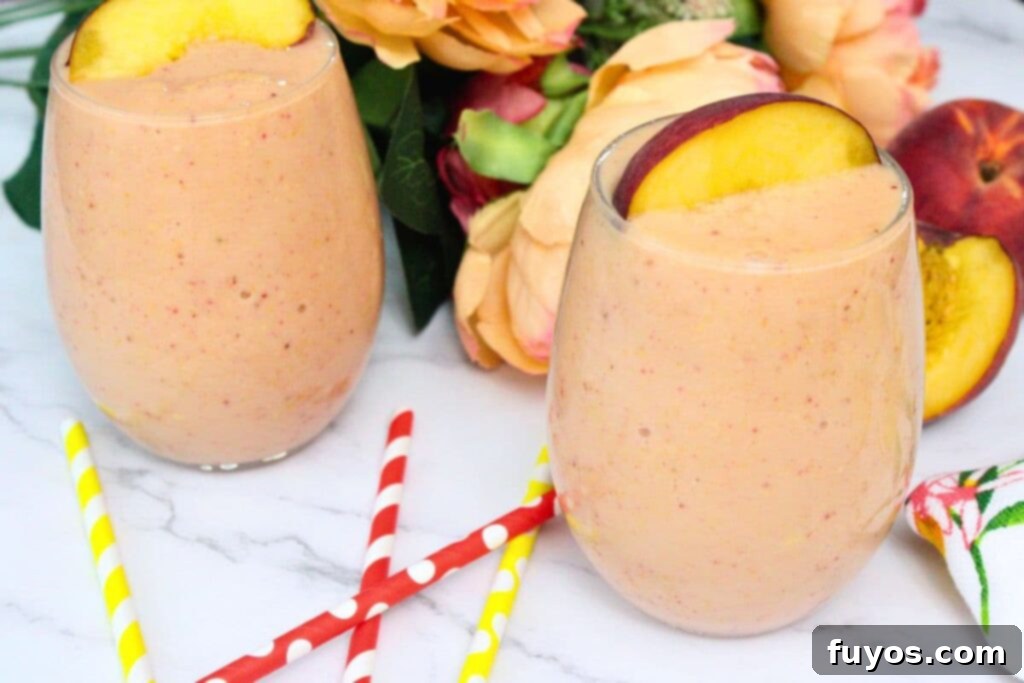 Peach Strawberry Mango Summer Bliss Smoothie 3 Two vibrant peach strawberry mango smoothies garnished with colorful straws and fresh fruit slices, set against a summer backdrop with flowers.