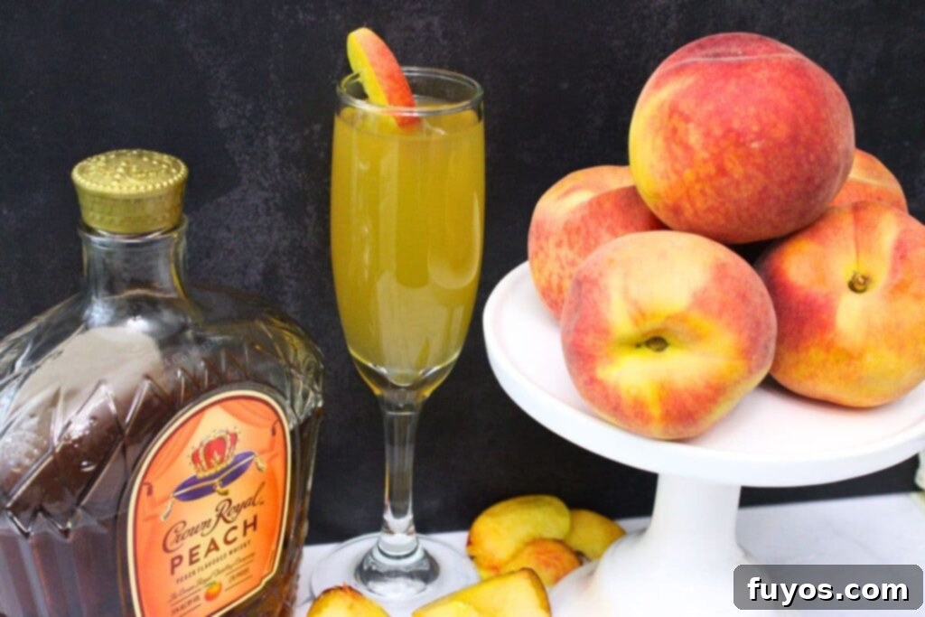 crown royal peach mimosa next to the bottle and a stack of peaches