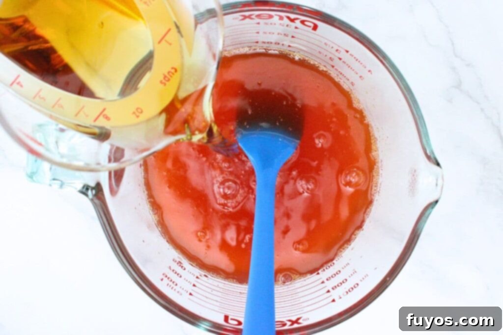 Effortless Crown Peach Jello Shots With Only Four Ingredients 7 stir crown royal peach whisky into jello mixture