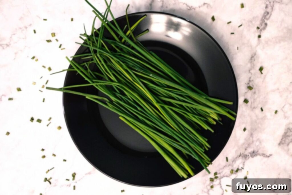 Effortless Air Fryer Chive Preservation 3 clean fresh chives stalks on a plate
