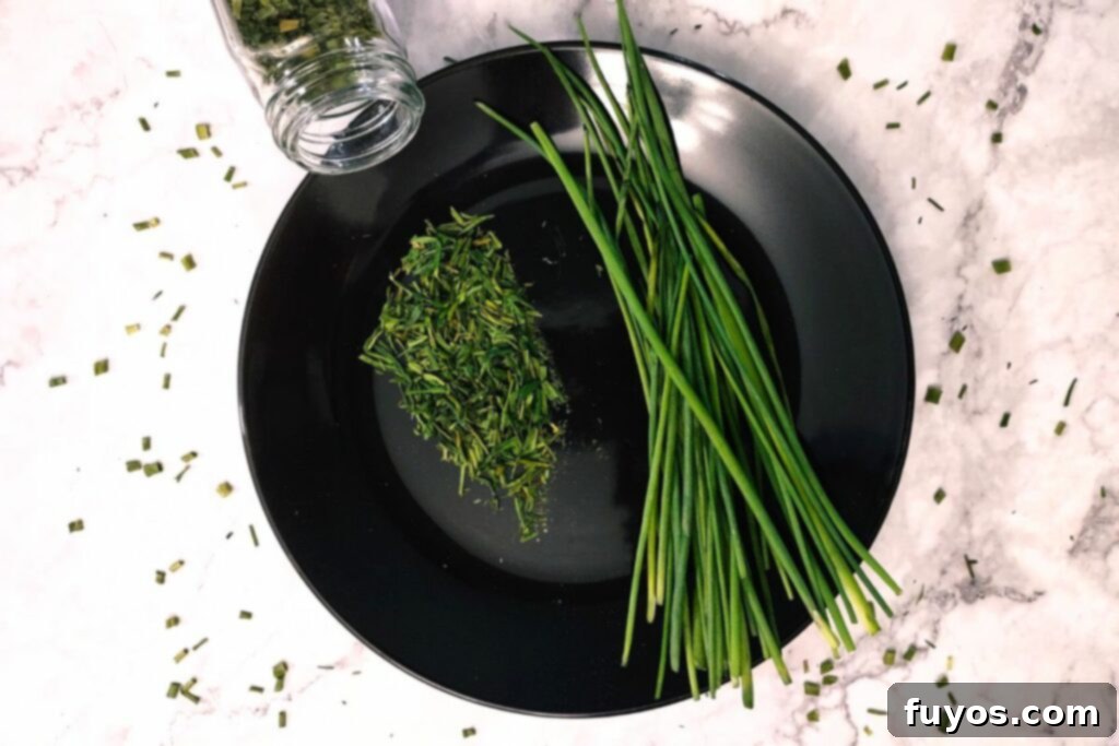 Effortless Air Fryer Chives Drying Quick Herb Preservation 8 dried chives on a plate spilling out of glass spice jar