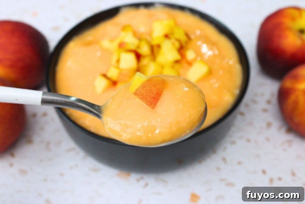 Effortless Peach Pudding in Minutes 3 holding up a spoonful of microwave peach pudding