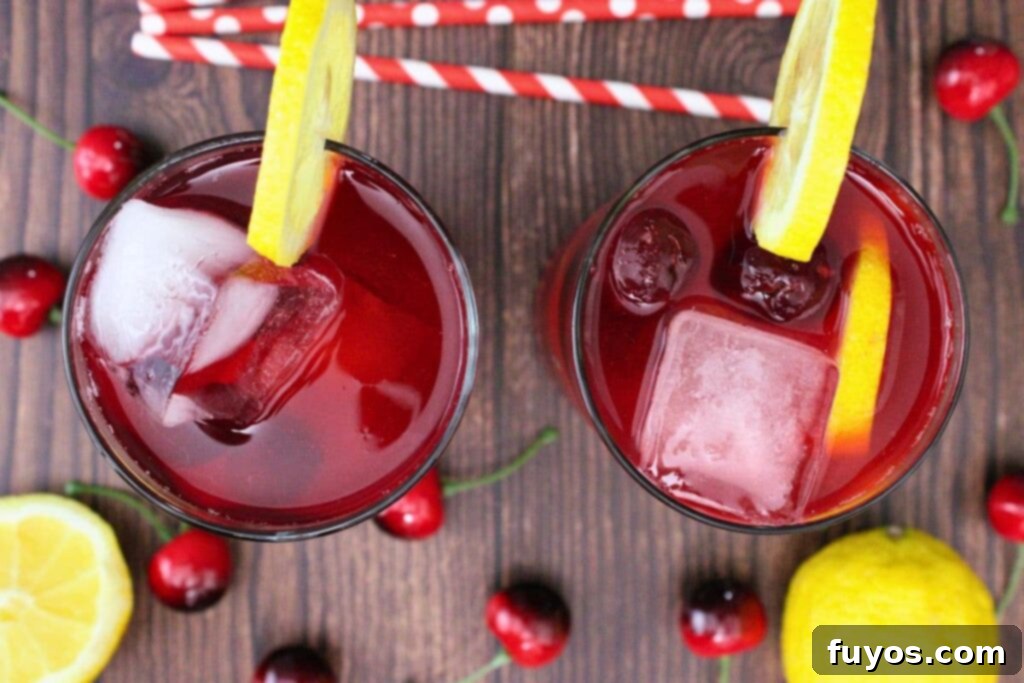 Effortless Cherry Vodka Lemonade 8 overhead view of two cherry vodka lemonade cocktails on a wooden table