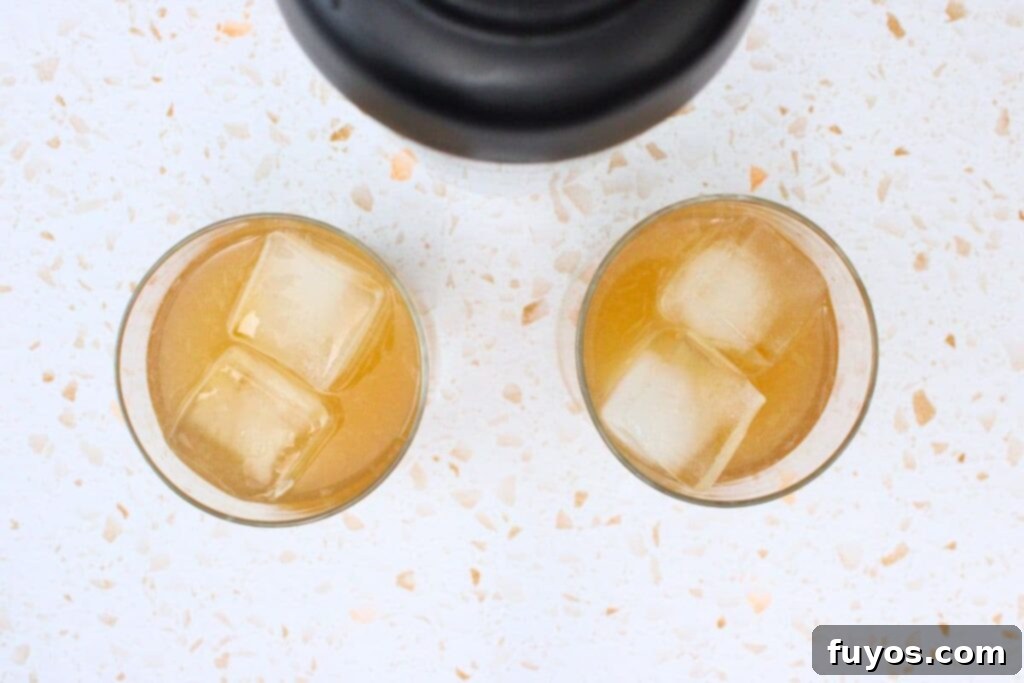strain peach whiskey sour into glass