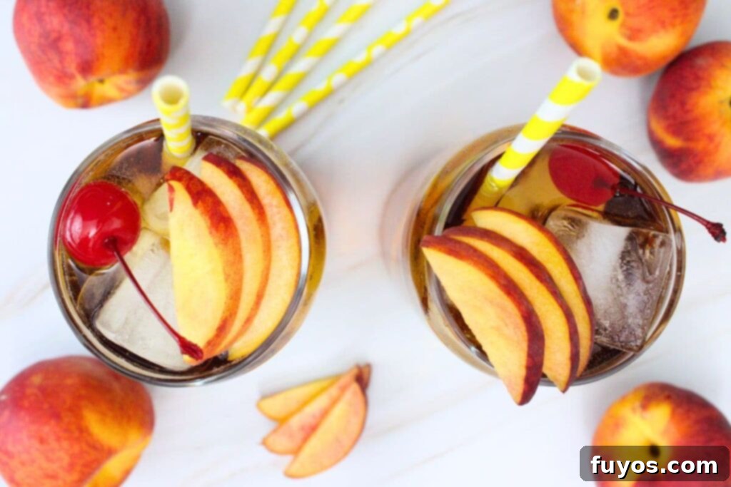 overhead view of two crown royal peach and cream soda drinks garnished with peach slices