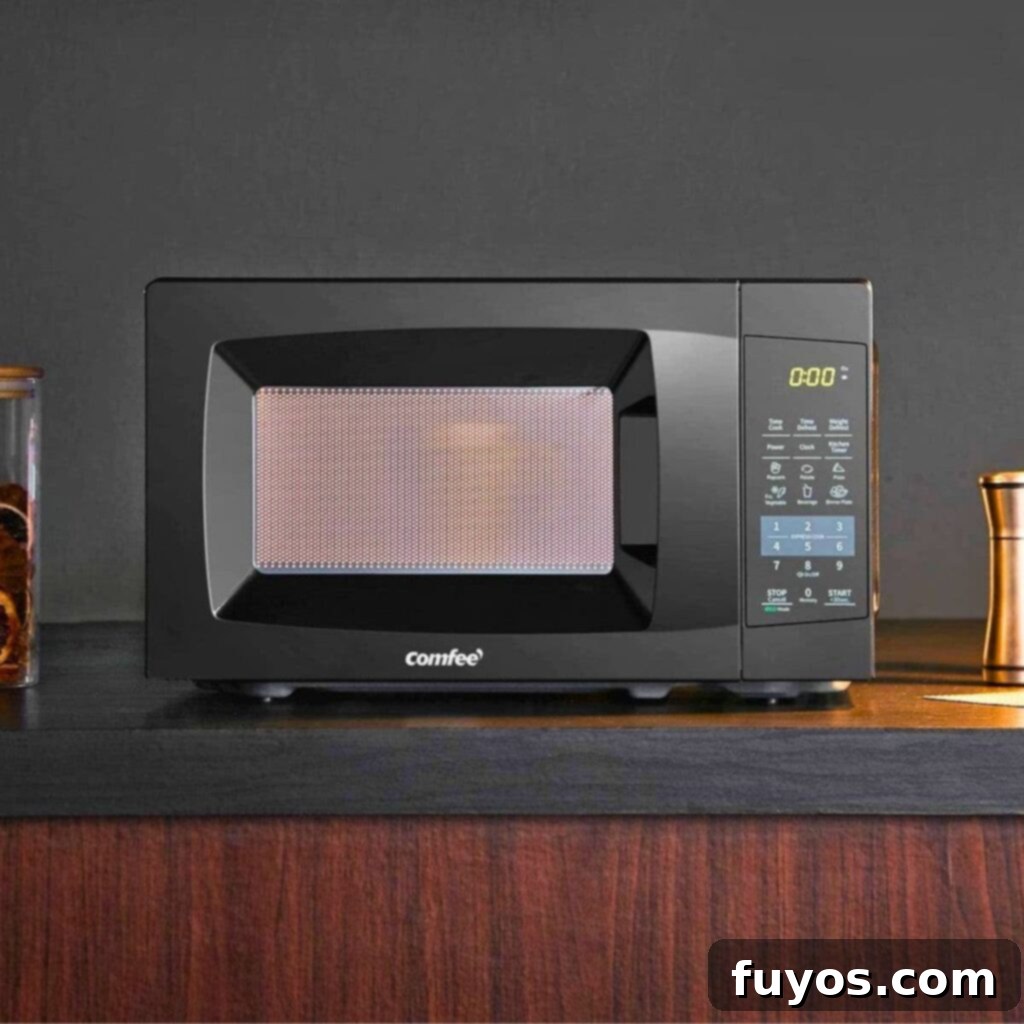 A student considers the best dorm microwave for their college living space, focusing on features like price, size, and power in a helpful buying guide.