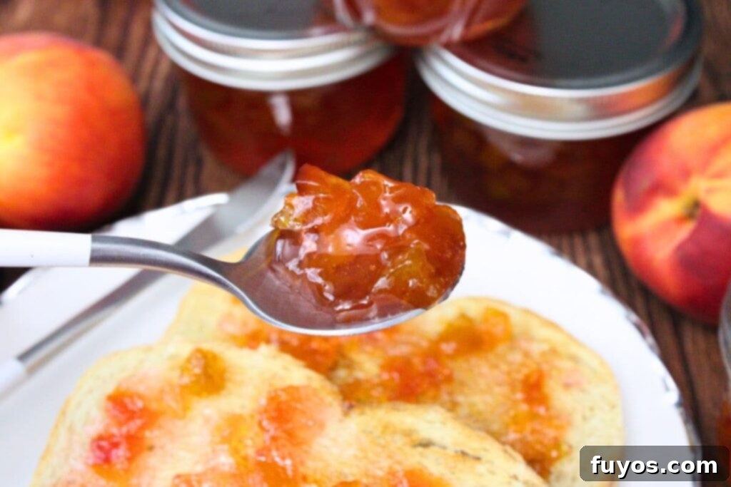 holding up a spoonful of microwave peach jam