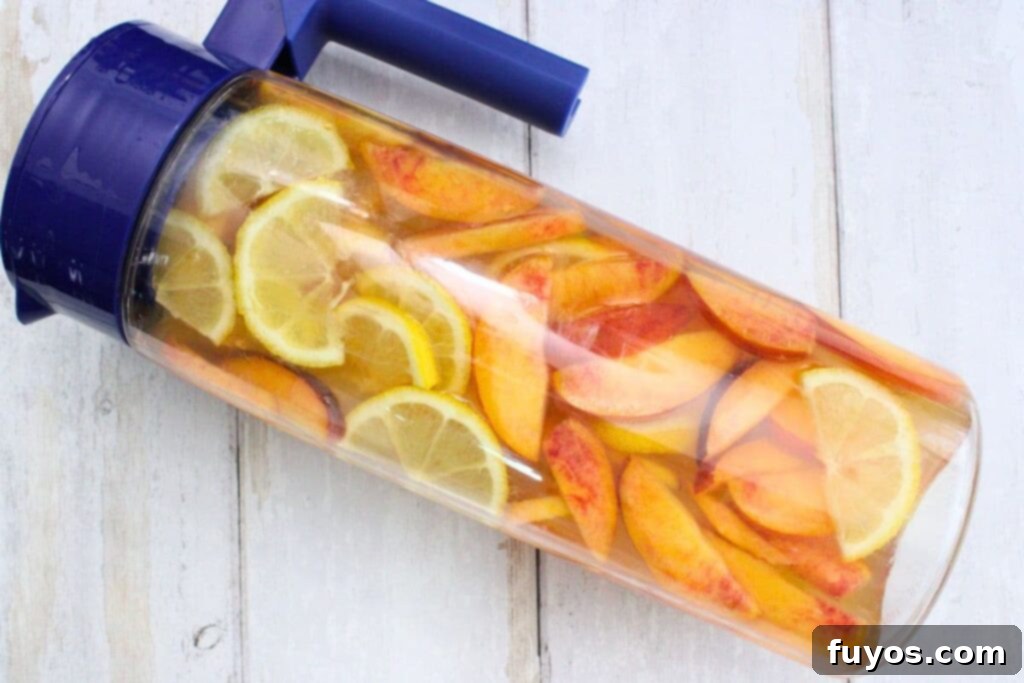 pour wine, whiskey, triple sec, peach juice, and simple syrup into the pitcher