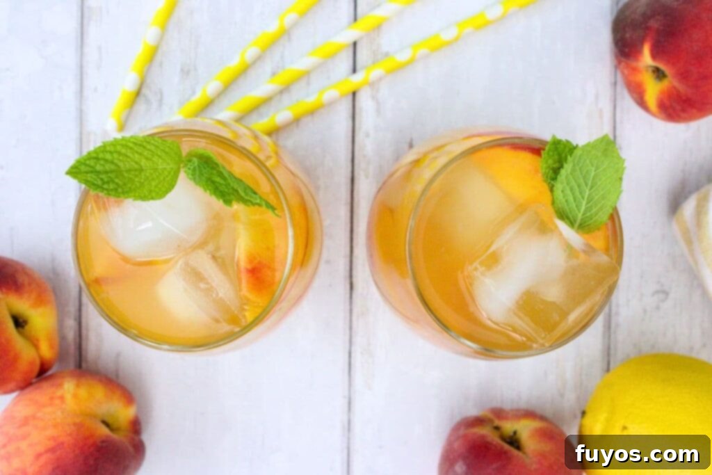 overhead view of two crown royal peach sangria drinks on a white wooden table