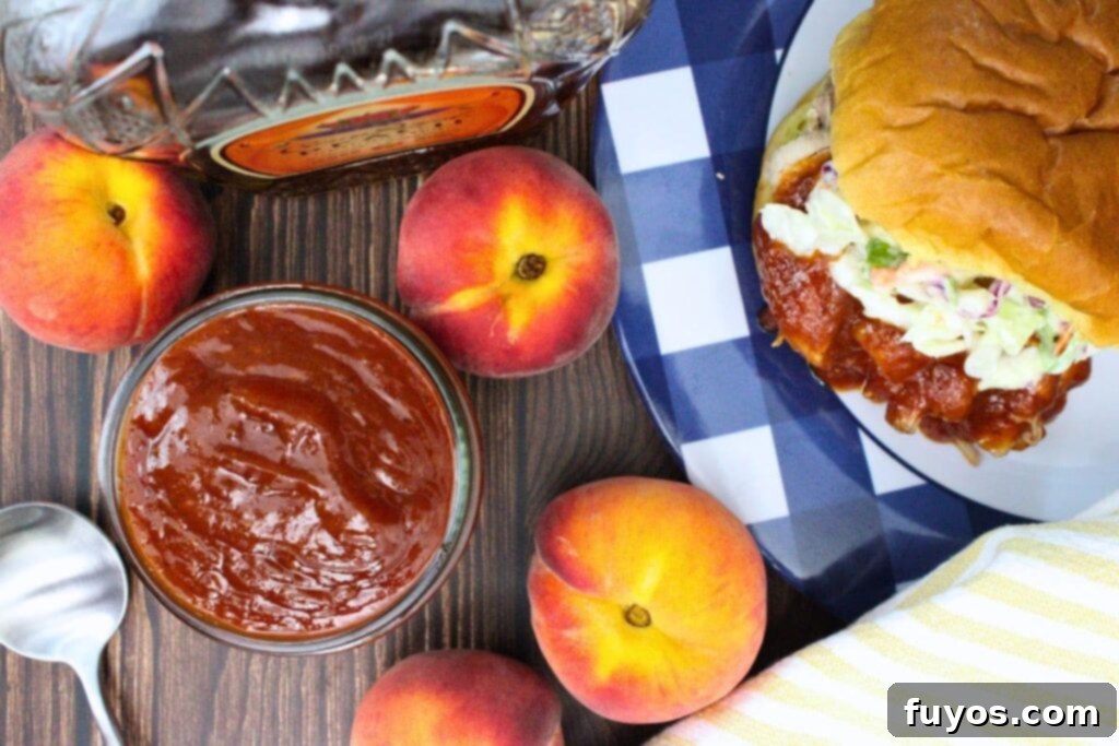 Whiskey Peach BBQ Sauce Homemade Microwave Ready 8 overhead view of a jar filled with whiskey peach bbq sauce next to a pulled pork sandwich