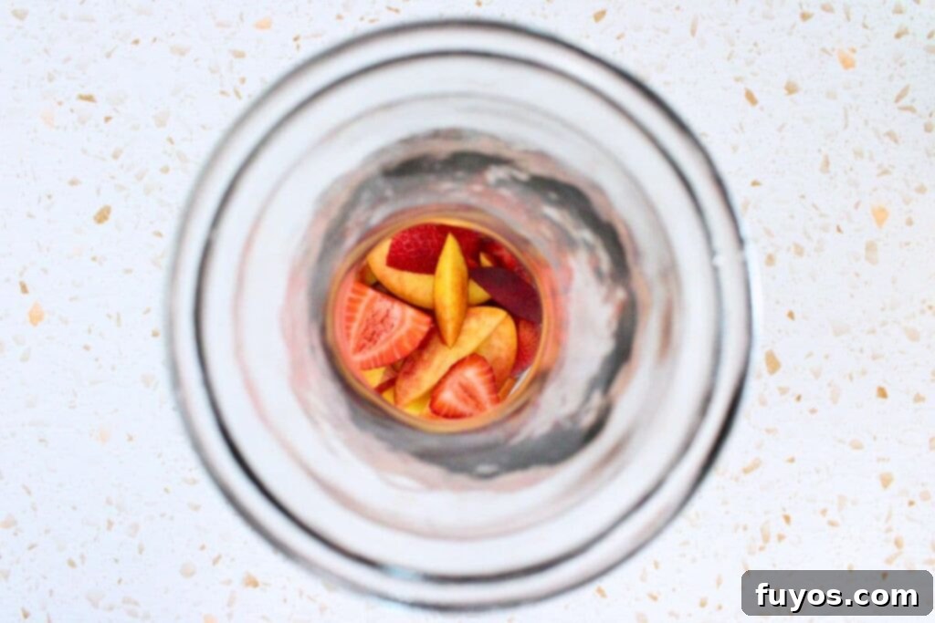 add cleaned and sliced peaches and fresh fruit to pitcher