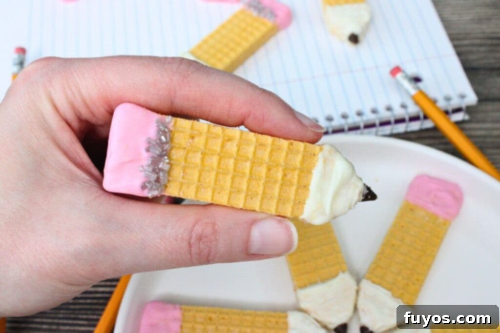Pencil Wafer Cookies Perfect for Back to School Fun 3 holding up a pencil wafer cookie