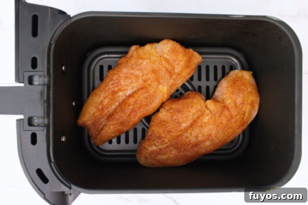 Simple Air Fryer Peach Whiskey BBQ Chicken Recipe 7 Place seasoned chicken breasts face down in a single layer in the air fryer basket for even cooking.