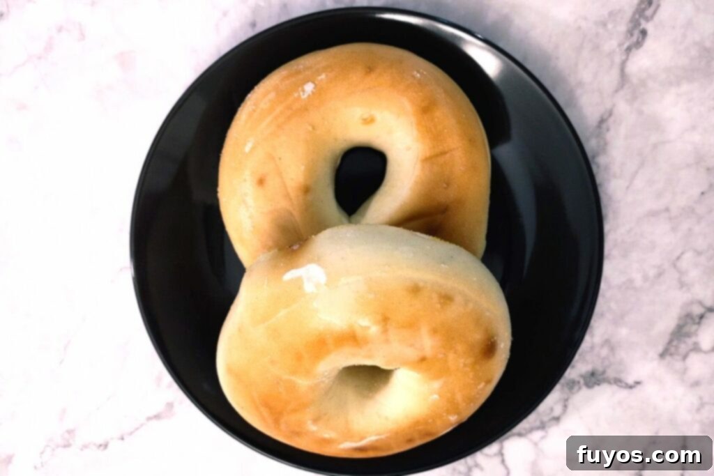 The Secret to Warm Fluffy Air Fryer Bagels 3 Taking a frozen bagel out of the freezer, illustrating the starting point for air fryer defrosting.