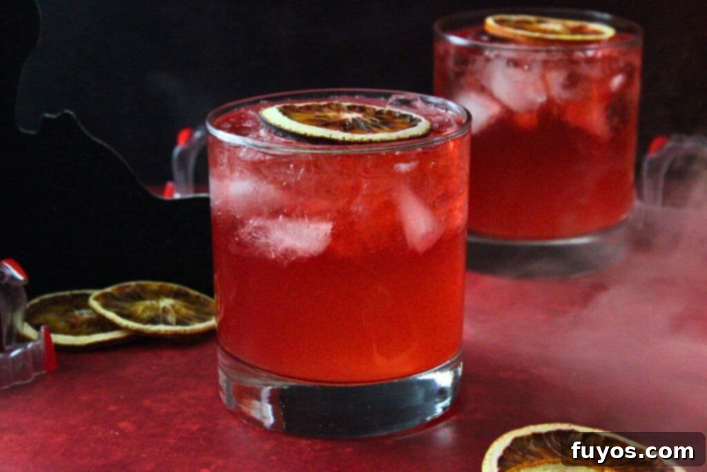 Blood Moon Rum Potion Zesty Halloween Brew 9 two blood moon cocktail drinks on a deep red counter with smoky mist, creating an atmospheric effect