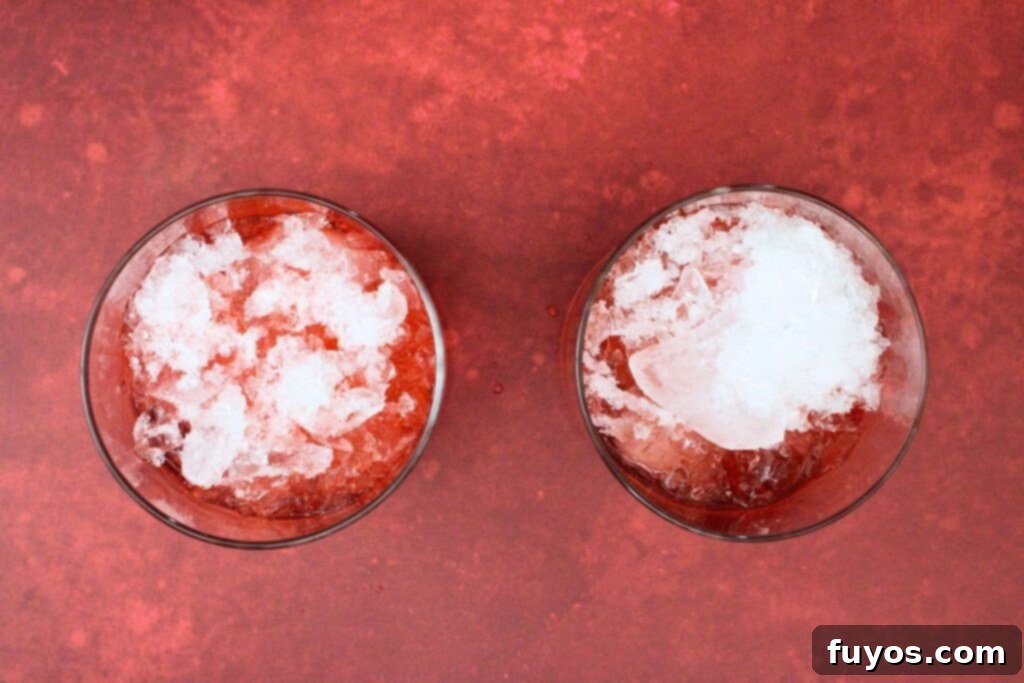 Blood Moon Rum Potion Zesty Halloween Brew 6 filling blood moon cocktail glass with crushed ice to create a refreshing drink
