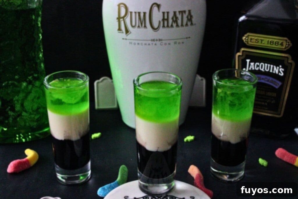 Beetlejuice Shot Layered Halloween Party Drink 3 three beetlejuice shot drinks in front of liquor bottles
