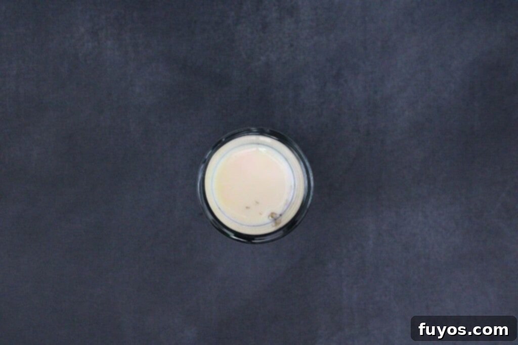 Beetlejuice Shot Layered Halloween Party Drink 6 slowly pour rumchata over a spoon to layer in shot glass