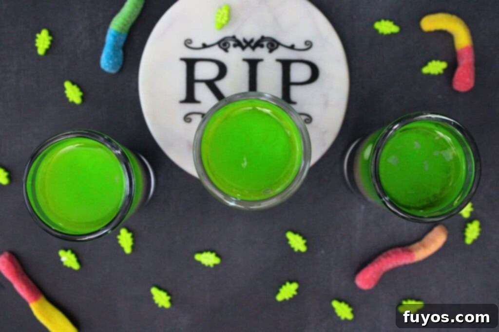 Beetlejuice Shot Layered Halloween Party Drink 8 overhead view of three layered beetlejuice shots surrounded by sour gummy worms