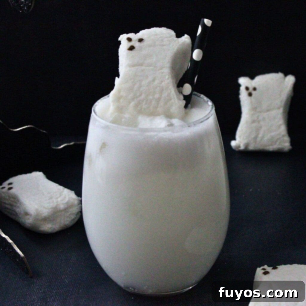 Two Drunk Ghost Cocktails with coconut rum and vanilla vodka bottles, garnished with ghost peep marshmallows for a spooky Halloween party.