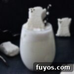 A ghostly white Drunk Ghost Cocktail, garnished with a marshmallow peep, ready for a Halloween celebration.